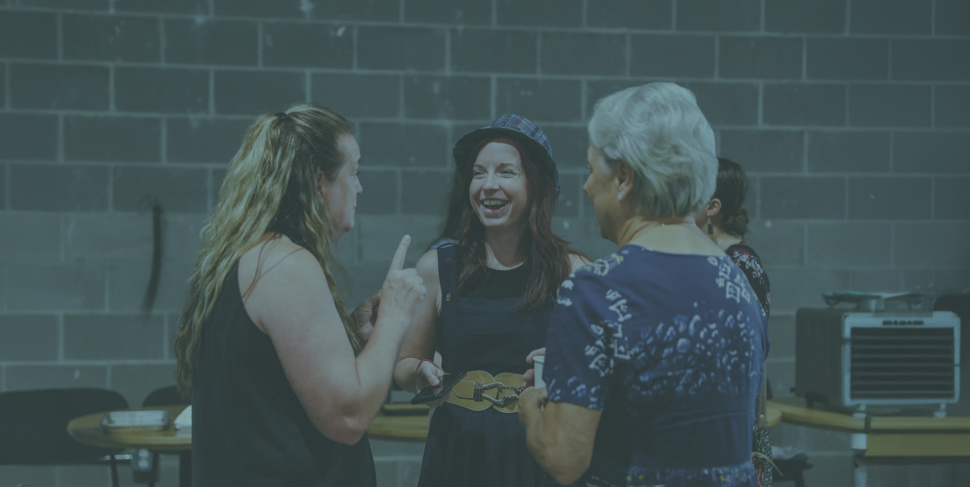 Three women chatting in the foyer after service